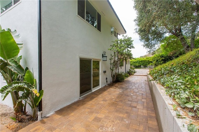 14879 Jadestone Dr, Sherman Oaks, CA 91403 - view of side of property featuring stucco siding and a patio area