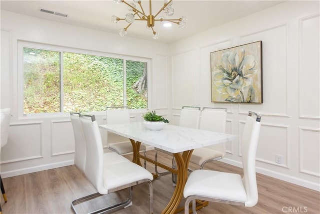 14879 Jadestone Dr, Sherman Oaks, CA 91403 - dining area featuring a decorative wall, light wood finished floors, and a chandelier