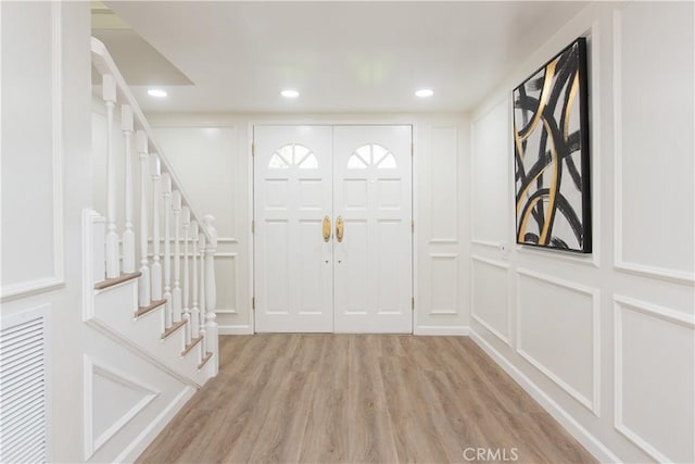 14879 Jadestone Dr, Sherman Oaks, CA 91403 - foyer entrance with light wood-type flooring, stairs, a decorative wall, and recessed lighting