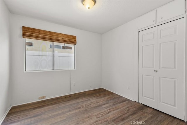 28265 Valombrosa Dr, Menifee, CA 92584 - unfurnished bedroom featuring wood finished floors, a closet, and baseboards