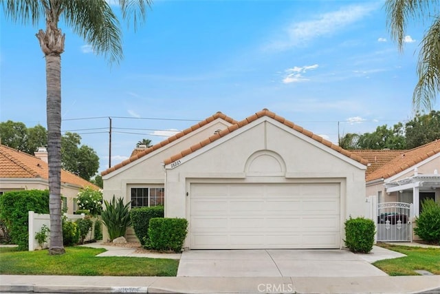 28265 Valombrosa Dr, Menifee, CA 92584 - mediterranean / spanish-style house with concrete driveway, a tiled roof, stucco siding, and a garage
