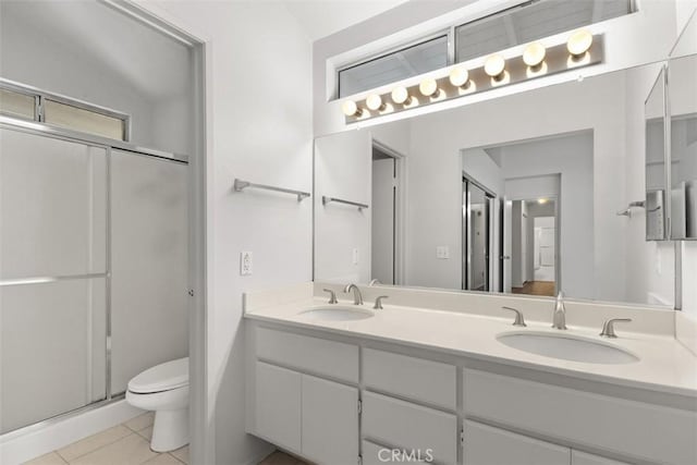 28265 Valombrosa Dr, Menifee, CA 92584 - bathroom featuring toilet, double vanity, tile patterned floors, and a shower stall