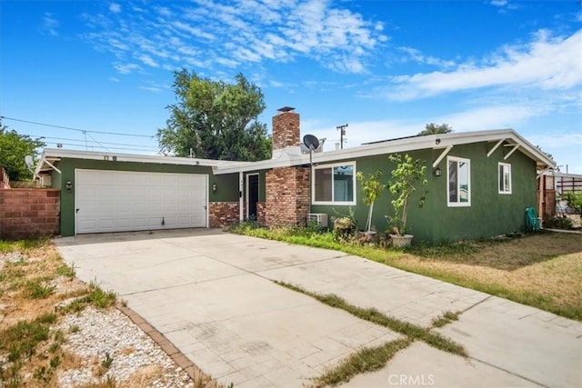 44128 Stanridge Ave, Lancaster, CA 93535 - ranch-style home featuring a garage, stucco siding, concrete driveway, and a chimney