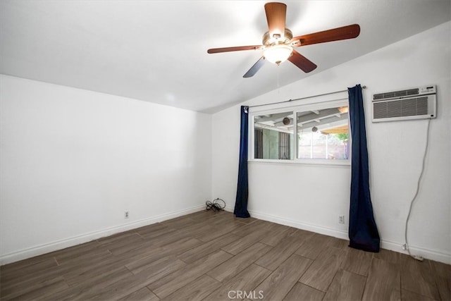 44128 Stanridge Ave, Lancaster, CA 93535 - spare room featuring vaulted ceiling, wood finished floors, a ceiling fan, a wall mounted AC, and baseboards