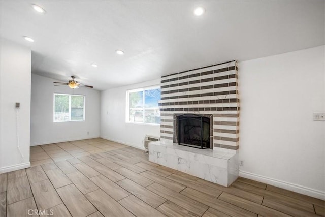 44128 Stanridge Ave, Lancaster, CA 93535 - unfurnished living room featuring wood finish floors, a large fireplace, recessed lighting, ceiling fan, and baseboards