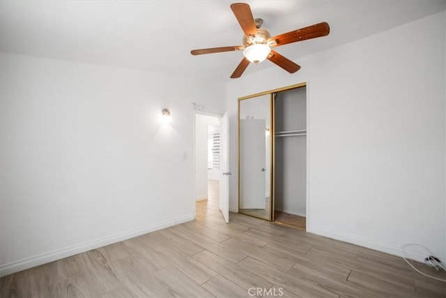 44128 Stanridge Ave, Lancaster, CA 93535 - unfurnished bedroom with wood finished floors, a closet, baseboards, and a ceiling fan