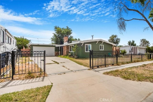 44128 Stanridge Ave, Lancaster, CA 93535 - view of front of house with concrete driveway, a chimney, a fenced front yard, stucco siding, and a garage