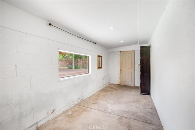 44128 Stanridge Ave, Lancaster, CA 93535 - empty room featuring concrete flooring, recessed lighting, and concrete block wall