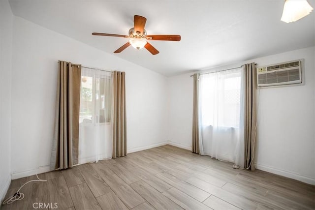 44128 Stanridge Ave, Lancaster, CA 93535 - empty room with a wall mounted AC, lofted ceiling, light wood-style flooring, ceiling fan, and baseboards