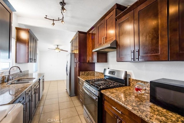 44128 Stanridge Ave, Lancaster, CA 93535 - kitchen with stainless steel appliances, under cabinet range hood, a sink, dark stone countertops, and ceiling fan