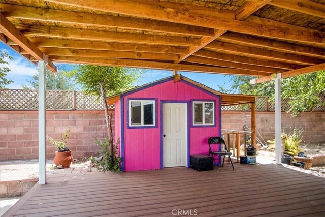 44128 Stanridge Ave, Lancaster, CA 93535 - wooden deck featuring a fenced backyard and an outbuilding