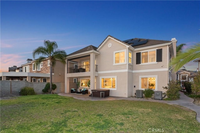 18762 Pimlico, Yorba Linda, CA 92886 - back of house featuring a balcony, roof mounted solar panels, a patio area, central air condition unit, and stucco siding