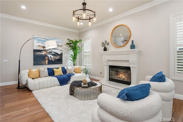 18762 Pimlico, Yorba Linda, CA 92886 - living room featuring light wood-style floors, a chandelier, a glass covered fireplace, ornamental molding, and recessed lighting