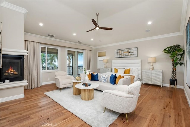 18762 Pimlico, Yorba Linda, CA 92886 - living room with ceiling fan, baseboards, crown molding, light wood-style flooring, and a glass covered fireplace