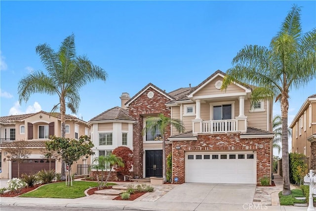 18762 Pimlico, Yorba Linda, CA 92886 - view of front of home featuring an attached garage, concrete driveway, brick siding, and a balcony