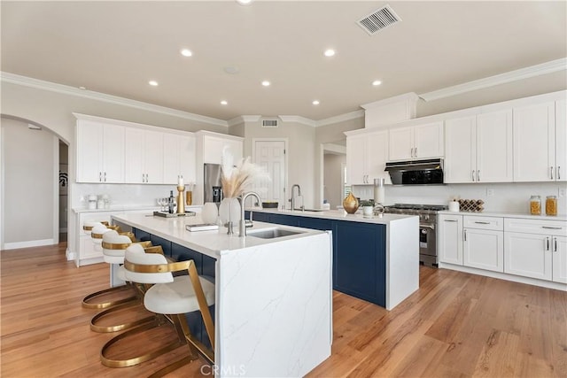 18762 Pimlico, Yorba Linda, CA 92886 - kitchen featuring stainless steel appliances, a kitchen island with sink, a sink, arched walkways, and recessed lighting