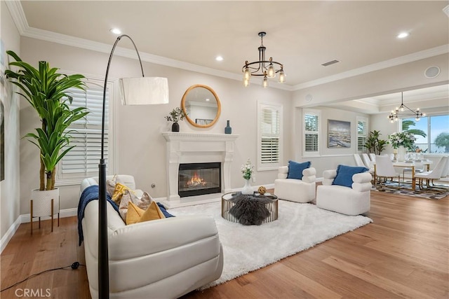18762 Pimlico, Yorba Linda, CA 92886 - living area featuring a chandelier, wood finished floors, a glass covered fireplace, ornamental molding, and recessed lighting