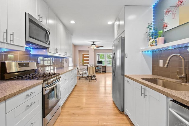 5441 Pennsylvania Ln, La Mesa, CA 91942 - kitchen with stainless steel appliances, a sink, tasteful backsplash, light wood-style flooring, and recessed lighting