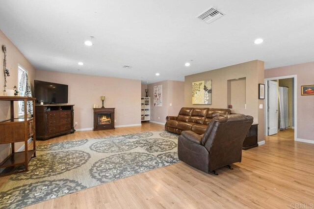 5441 Pennsylvania Ln, La Mesa, CA 91942 - living room featuring wood finished floors, baseboards, recessed lighting, and a warm lit fireplace