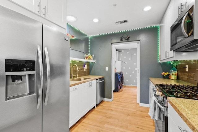 5441 Pennsylvania Ln, La Mesa, CA 91942 - kitchen with appliances with stainless steel finishes, a sink, light wood-style flooring, white cabinetry, and recessed lighting