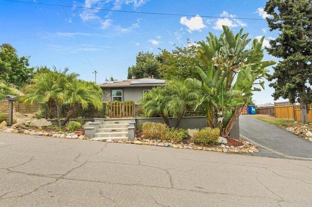 5441 Pennsylvania Ln, La Mesa, CA 91942 - obstructed view of property featuring roof mounted solar panels and a fenced front yard