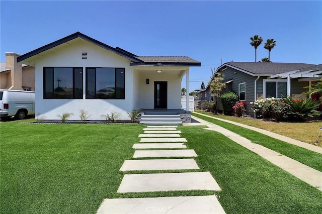 2015 W 42nd Pl, Los Angeles, CA 90062 - view of front facade featuring stucco siding and a front lawn