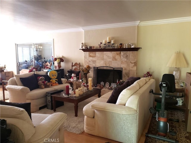 4148 Woodland St, Santa Maria, CA 93455 - living room featuring ornamental molding, a chandelier, a tile fireplace, and wood finished floors