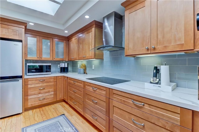 3521 Bahia Blanca W Unit C, Laguna Woods, CA 92637 - kitchen featuring stainless steel appliances, wall chimney range hood, light stone countertops, light wood-style flooring, and recessed lighting