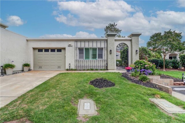 3521 Bahia Blanca W Unit C, Laguna Woods, CA 92637 - view of front of house with driveway, a front lawn, a garage, and stucco siding