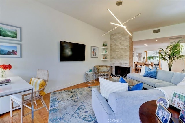 3521 Bahia Blanca W Unit C, Laguna Woods, CA 92637 - living room with wood finished floors, baseboards, and a fireplace