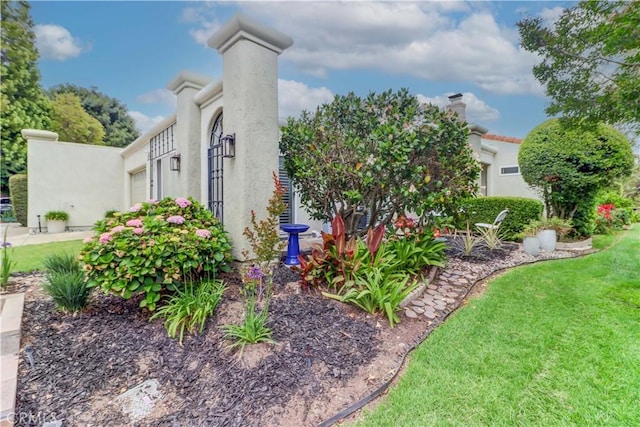 3521 Bahia Blanca W Unit C, Laguna Woods, CA 92637 - view of side of home featuring stucco siding and a lawn