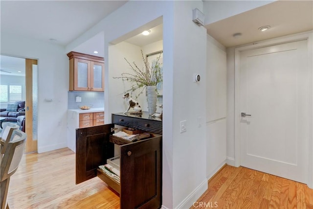 3521 Bahia Blanca W Unit C, Laguna Woods, CA 92637 - bar area with light wood-style flooring, decorative backsplash, and baseboards