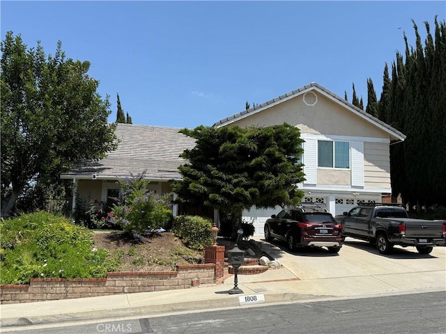 1808 Via Entrada, Rowland Heights, CA 91748 - obstructed view of property featuring a garage, concrete driveway, stucco siding, and a tile roof