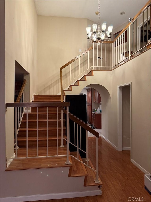 1808 Via Entrada, Rowland Heights, CA 91748 - stairway featuring a towering ceiling, wood finished floors, arched walkways, baseboards, and a chandelier