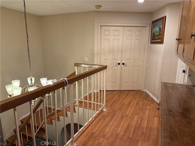 1808 Via Entrada, Rowland Heights, CA 91748 - corridor featuring light wood-type flooring, an upstairs landing, a chandelier, and baseboards
