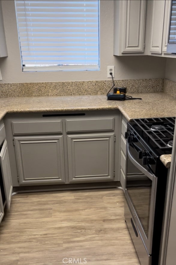 600 Central Ave Unit 302, Riverside, CA 92507 - kitchen featuring stainless steel gas stove, light wood-style flooring, light countertops, and gray cabinets