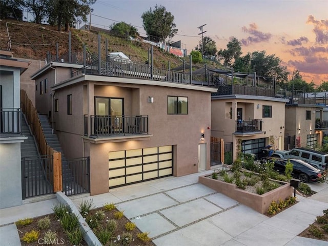 4850 Buchanan, Los Angeles, CA 90042 - view of front of property with driveway, a garage, a balcony, and stucco siding