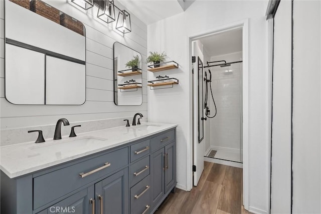 62 Wild Horse Loop Unit 29, Rancho Santa Margarita, CA 92688 - bathroom featuring a tile shower, wood finished floors, and double vanity