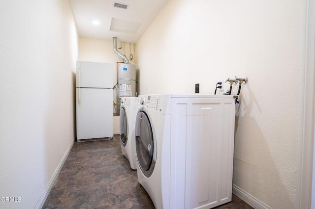 2947 Camino Del Zuro, Thousand Oaks, CA 91360 - laundry area with strapped water heater, washer and dryer, stone finish floors, and baseboards
