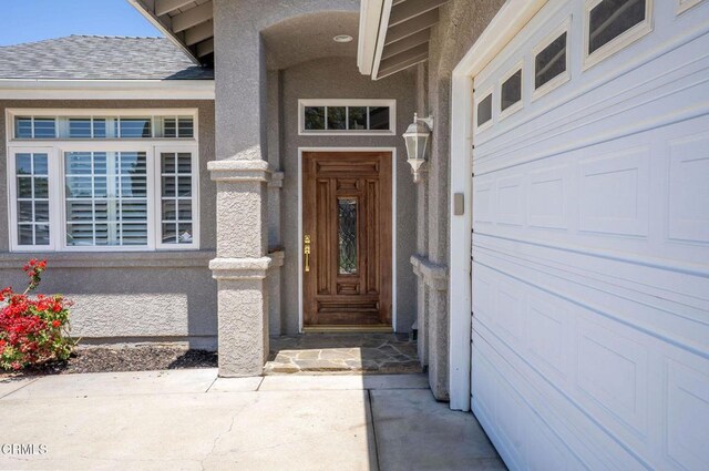 2947 Camino Del Zuro, Thousand Oaks, CA 91360 - doorway to property with stucco siding, a garage, and a shingled roof