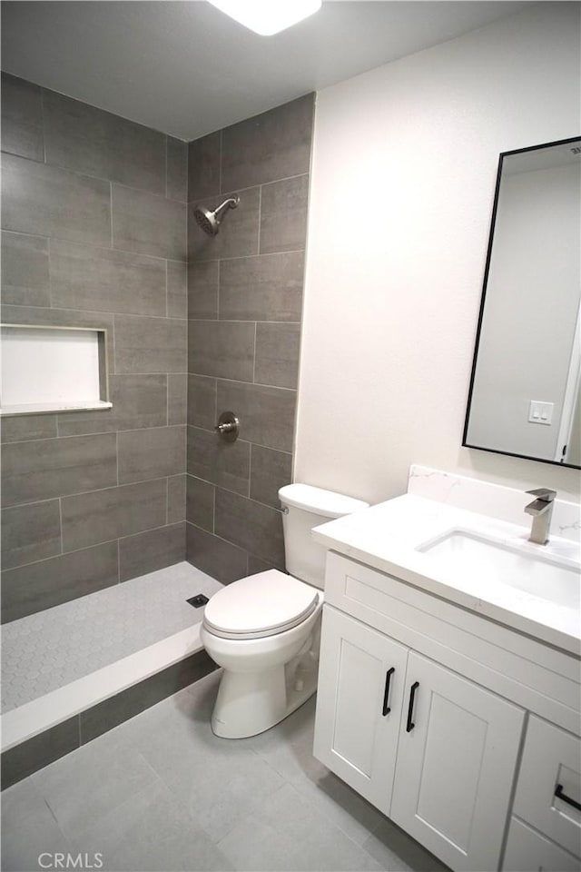 5187 Cedar St, Jurupa Valley, CA 92509 - bathroom with vanity, tiled shower, and tile patterned flooring