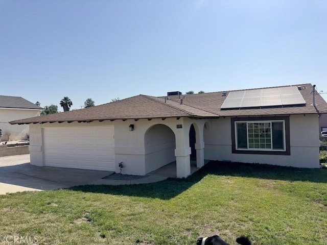 5187 Cedar St, Jurupa Valley, CA 92509 - view of front facade featuring solar panels, stucco siding, a garage, and a front yard