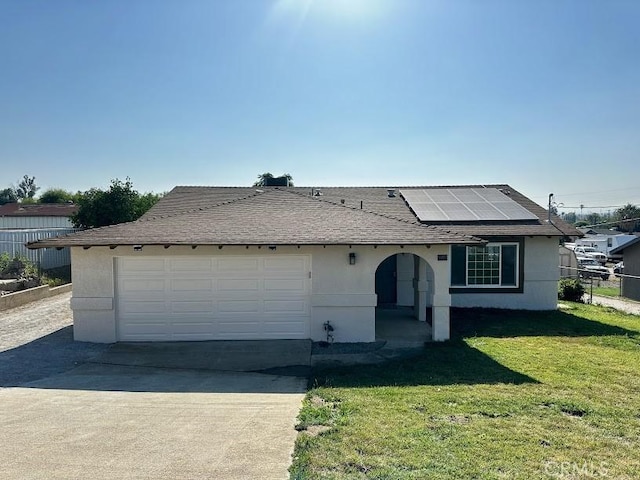 5187 Cedar St, Jurupa Valley, CA 92509 - view of front of house featuring solar panels, concrete driveway, an attached garage, roof with shingles, and stucco siding
