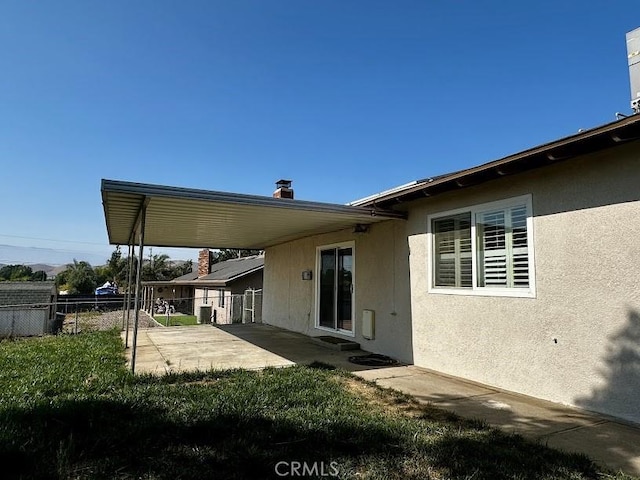 5187 Cedar St, Jurupa Valley, CA 92509 - rear view of house with a patio, stucco siding, and a chimney