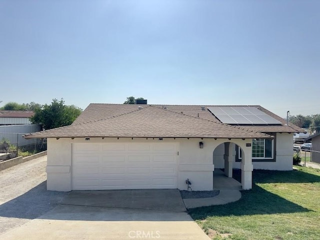 5187 Cedar St, Jurupa Valley, CA 92509 - view of front of property featuring roof mounted solar panels, roof with shingles, driveway, an attached garage, and stucco siding