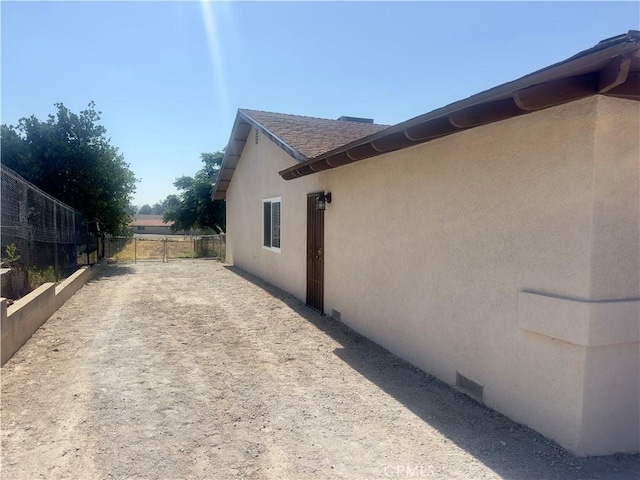 5187 Cedar St, Jurupa Valley, CA 92509 - view of side of property featuring stucco siding and roof with shingles
