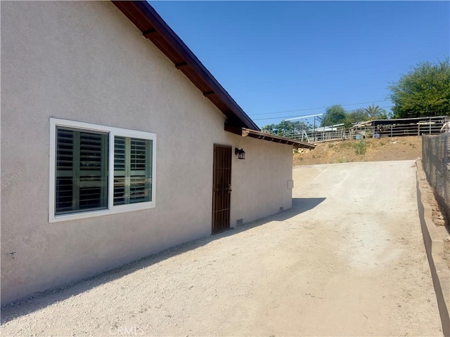 5187 Cedar St, Jurupa Valley, CA 92509 - view of side of home with a patio and stucco siding
