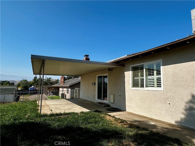 5187 Cedar St, Jurupa Valley, CA 92509 - back of house with a patio, stucco siding, and a carport
