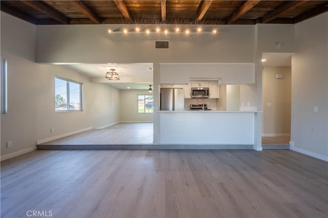 5187 Cedar St, Jurupa Valley, CA 92509 - unfurnished living room featuring a wooden ceiling with exposed beams, light wood finished floors, plenty of natural light, and ceiling fan