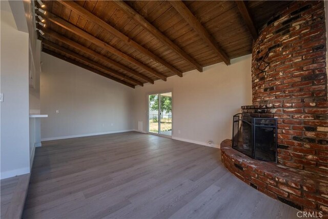 5187 Cedar St, Jurupa Valley, CA 92509 - unfurnished living room featuring a wood ceiling with exposed beams, a brick fireplace, wood finished floors, and high vaulted ceiling